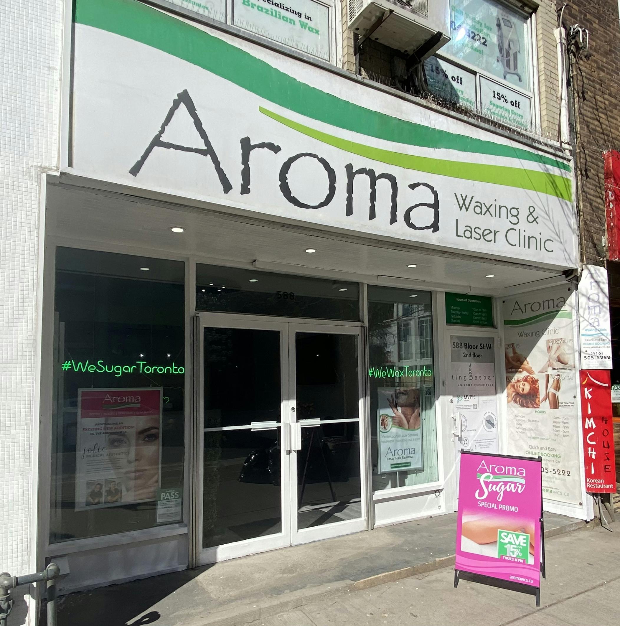 The storefront of Aroma Waxing and Laser Clinic (Bloor Street West location) with hours of operation, address.