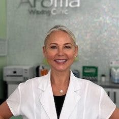 Mary Miljan, elegantly dressed in a white blouse, radiates the visionary spirit that propelled Aroma Waxing Clinic to the forefront of Toronto's spa scene