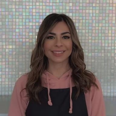 In her professional attire, Enza exudes confidence and warmth, embodying her decades of experience as the lead Sugarist at Aroma Waxing Clinic, where her passion for eyebrow design and laser hair removal shines